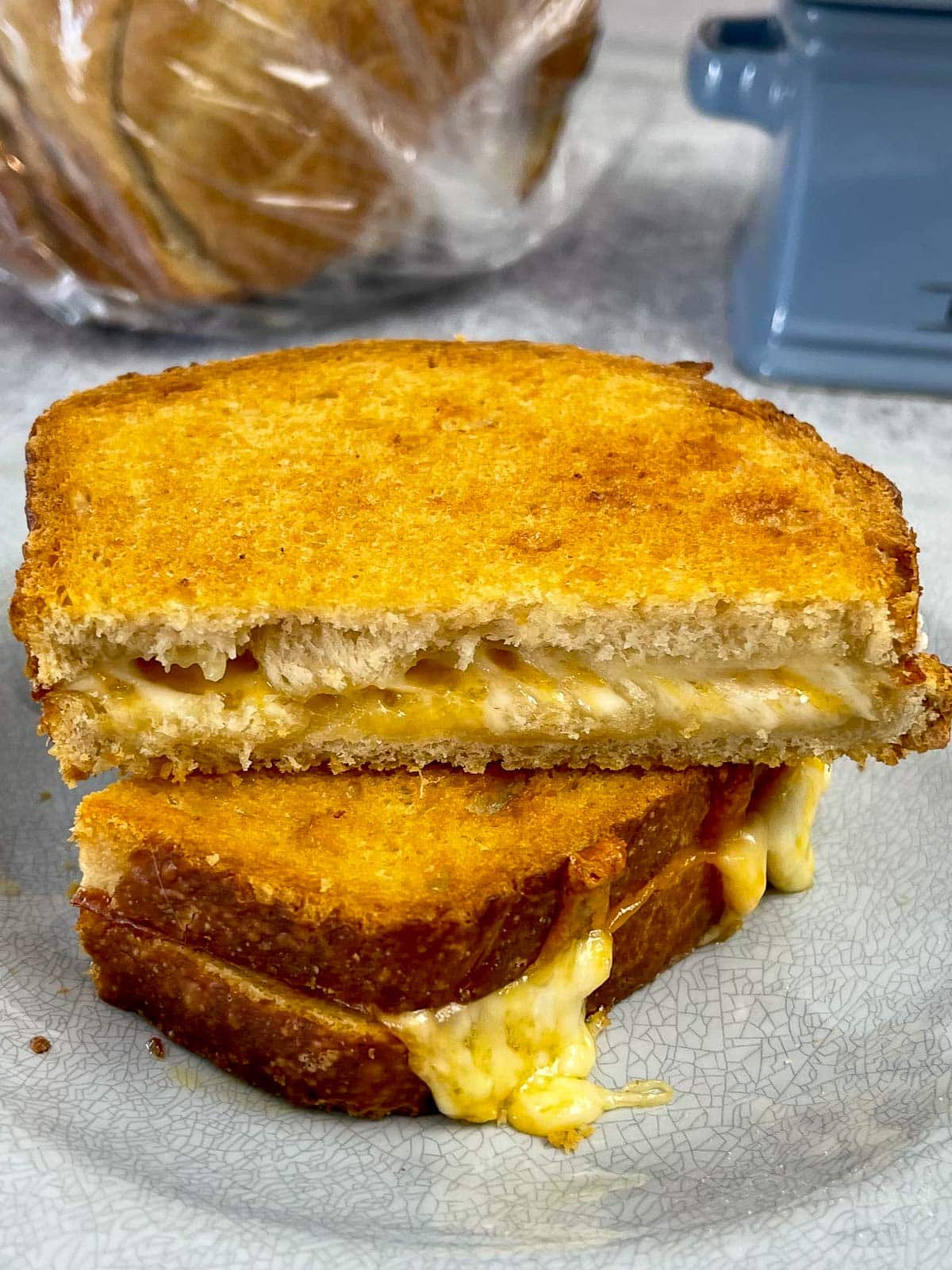 Air Fryer Grilled Cheese Sandwich cut in half with melty cheese running down the sides of the bread.