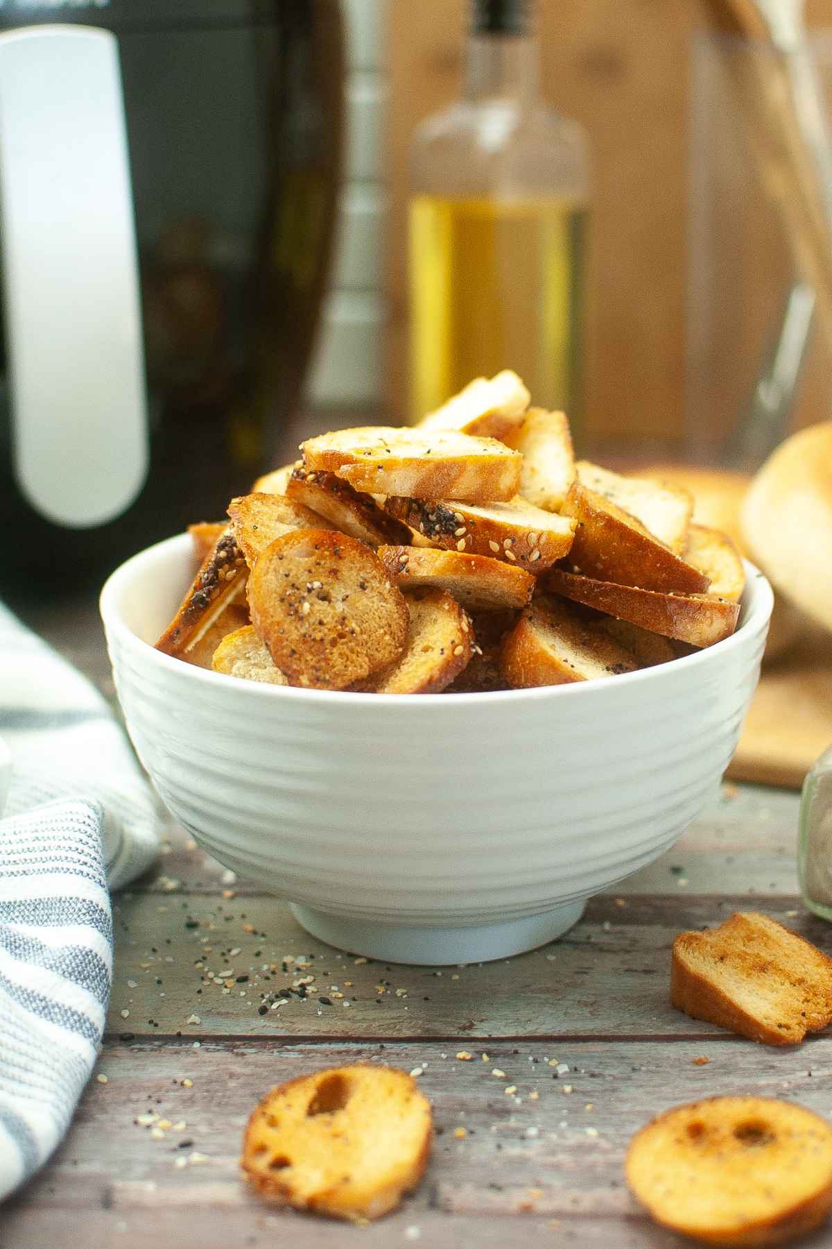 Golden Brown Bagel Chips in a white serving bowl.