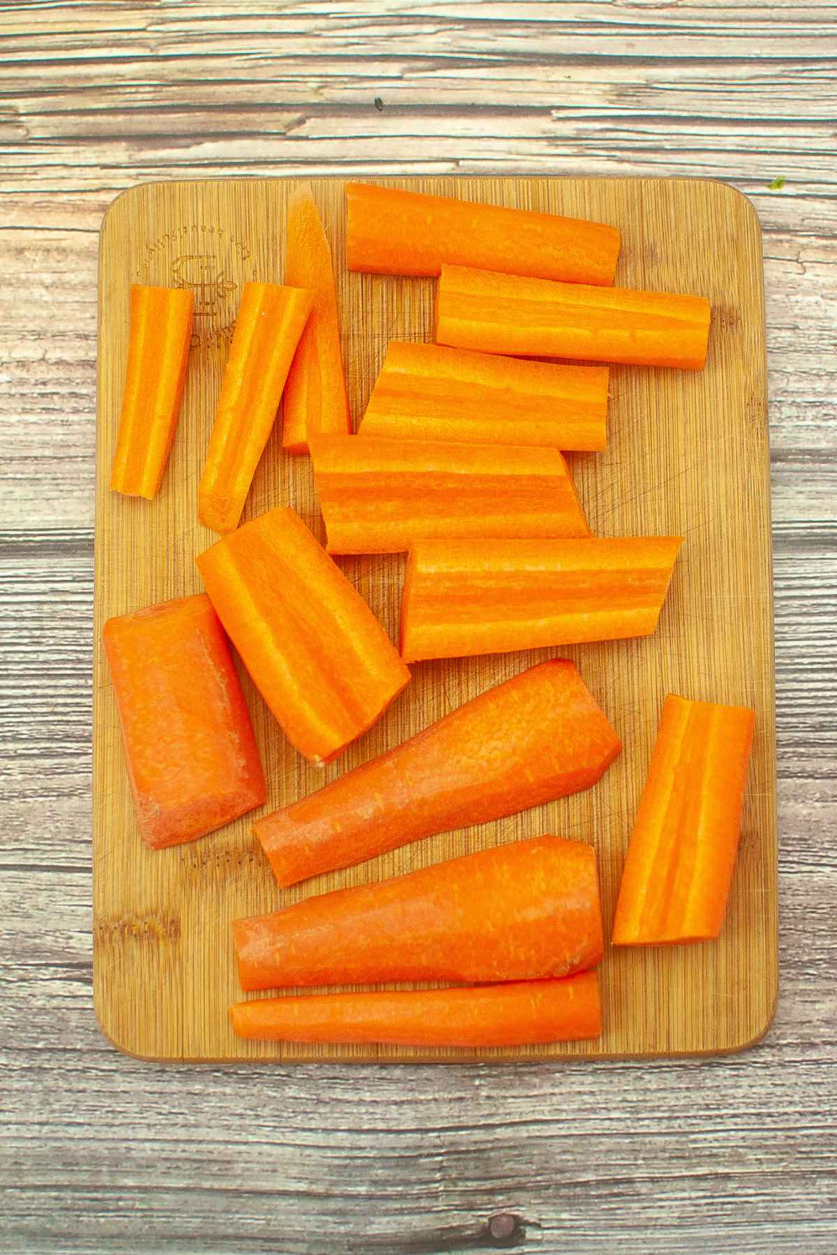 Cut carrots on a wooden board.