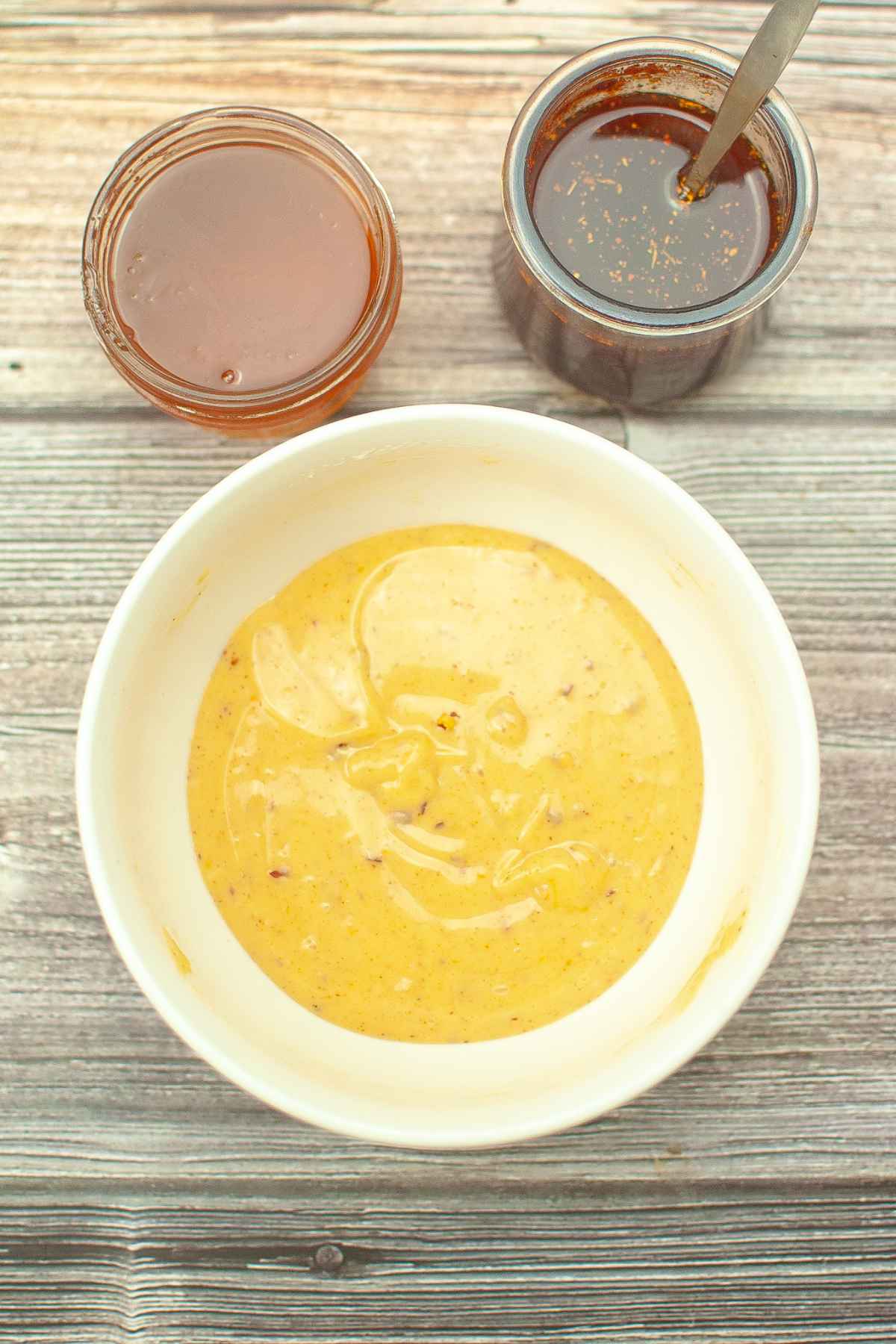 Sweet and spicy honey mixture in a white bowl.