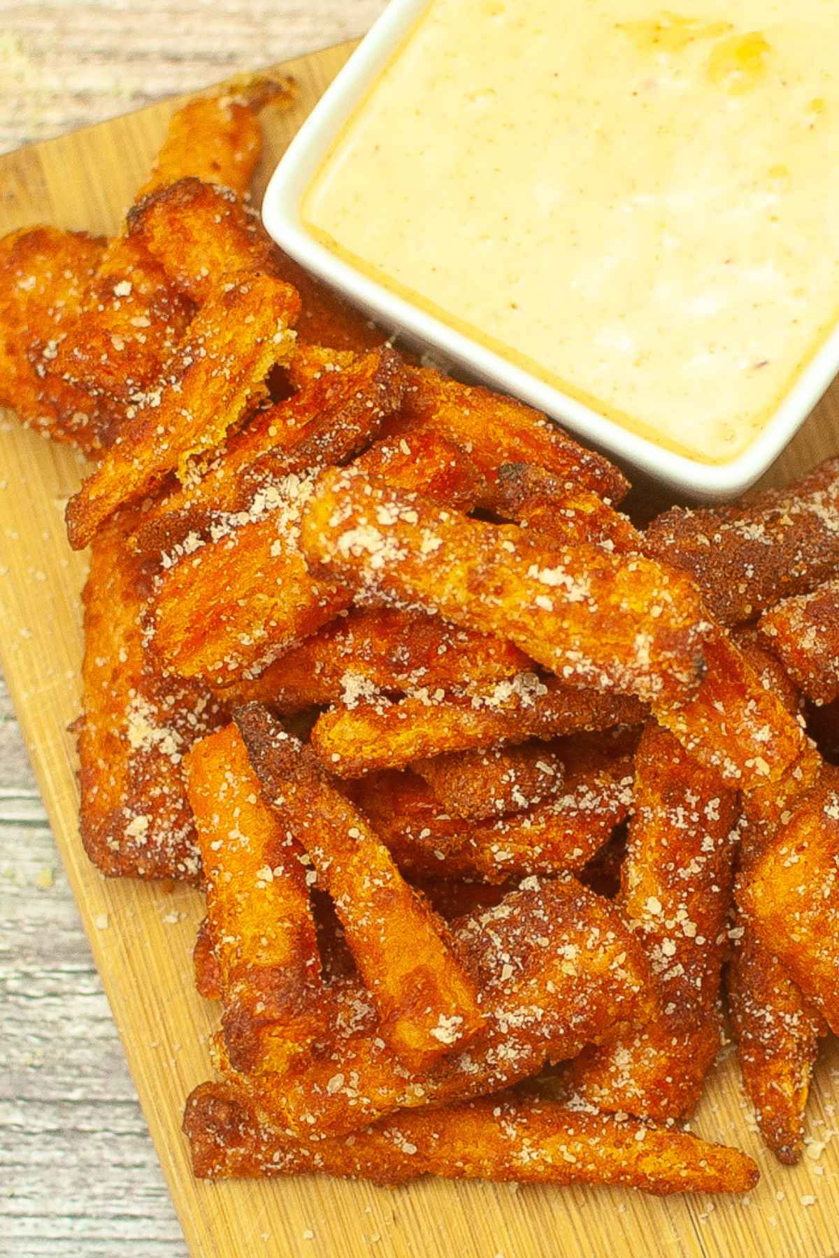 Overhead image of air fryer carrot fries with a side of sweet and spicy mayo.