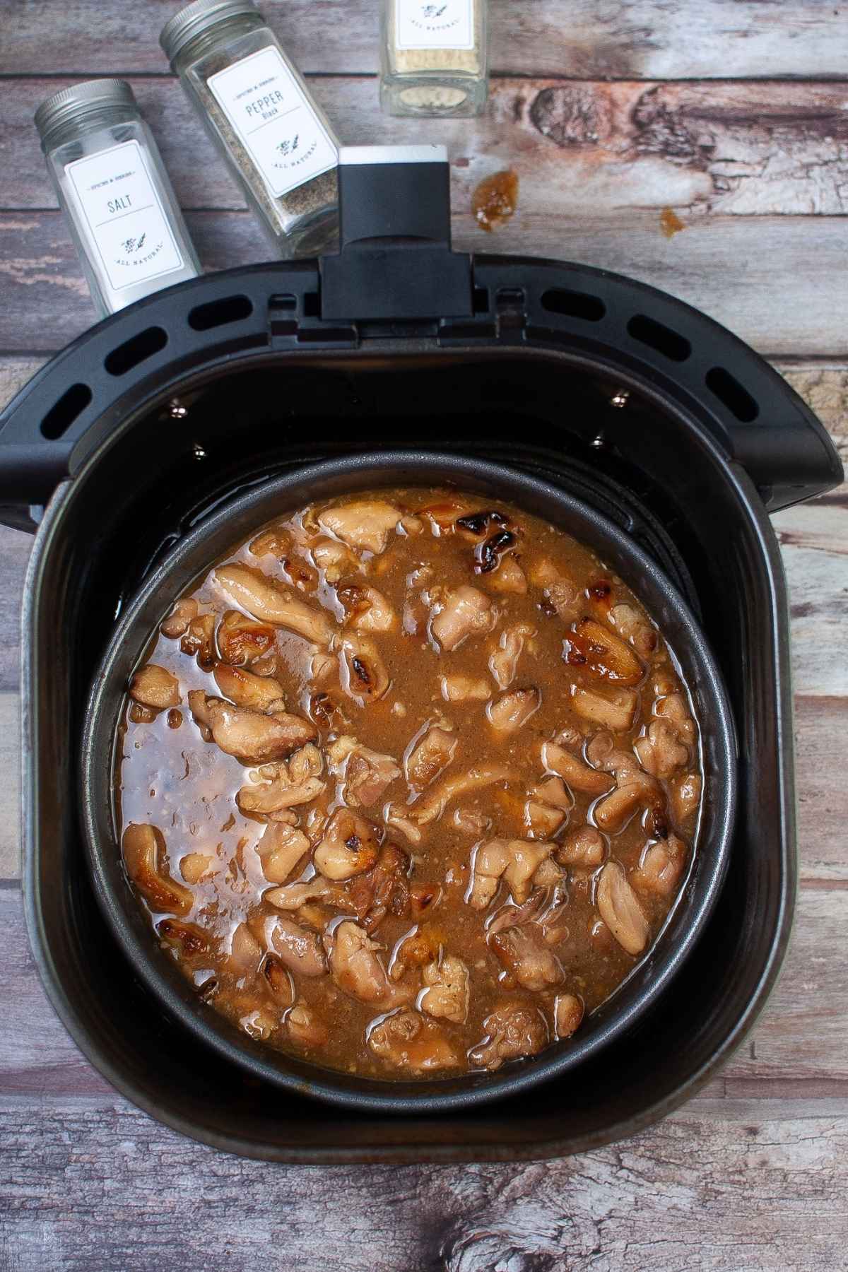 Cooked chicken in pan in air fryer.