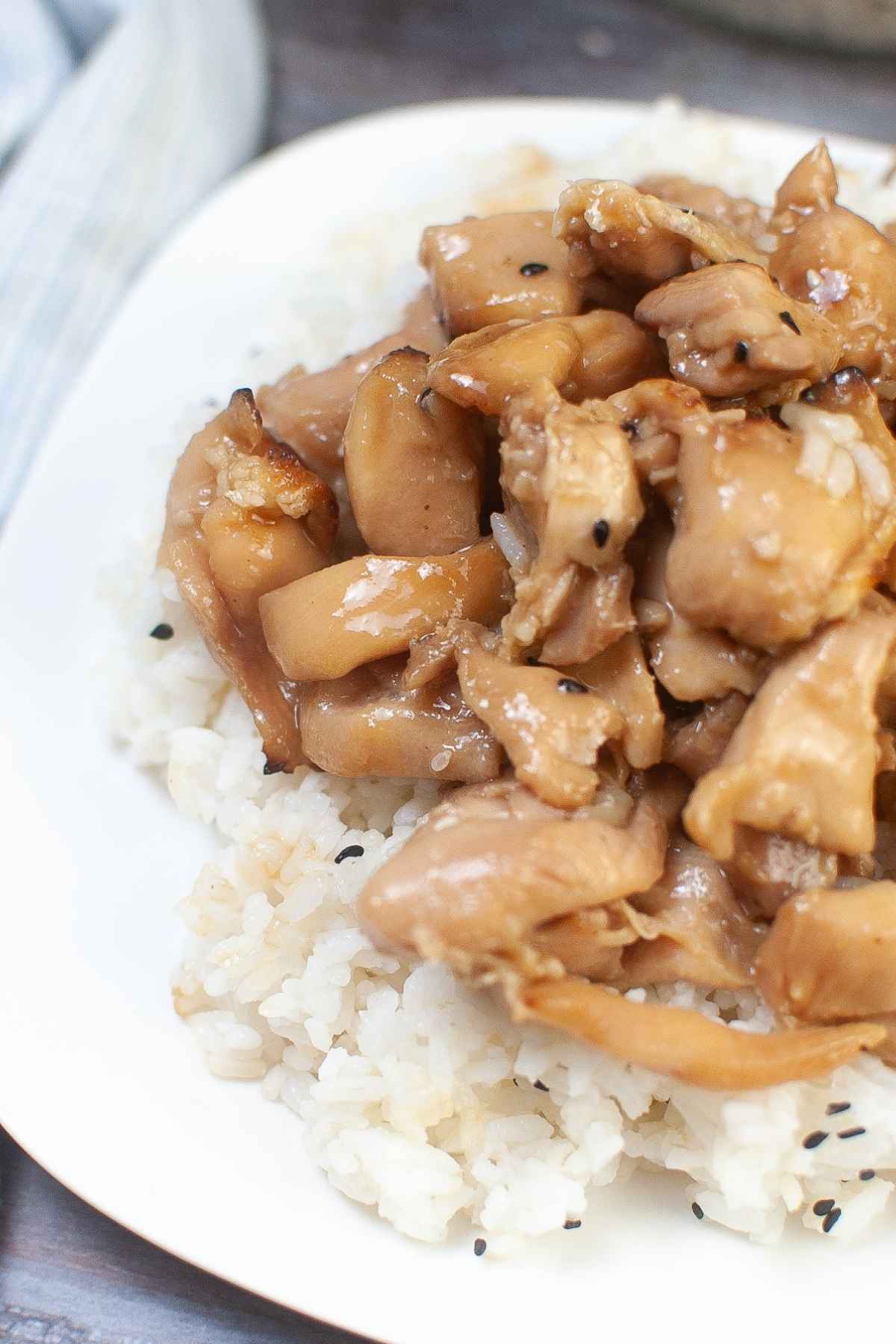 Upclose image of teriyaki chicken on a bed of white rice.