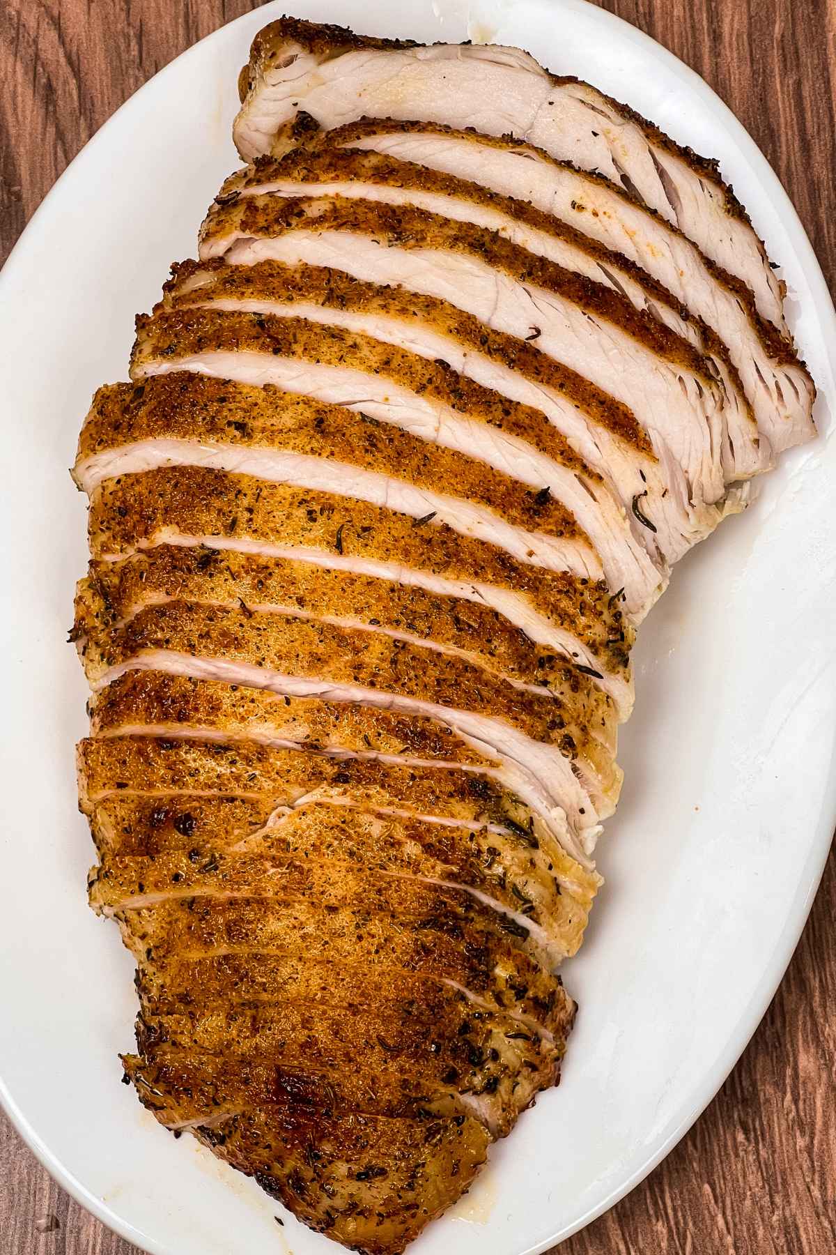 Sliced Air Fryer Turkey Tenderloins on a white tray.