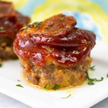 Featured image of Bacon Cheeseburger Meatloaf Muffin on a white plate.