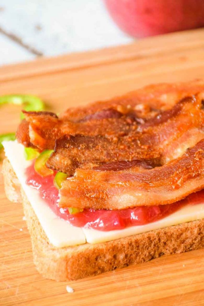 bottom layer of sandwich with bacon on top of rhubarb sauce recipe and jalapenos