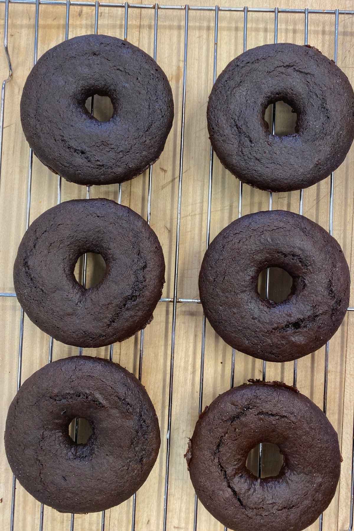 Baked Donuts cooling on a wire rack.