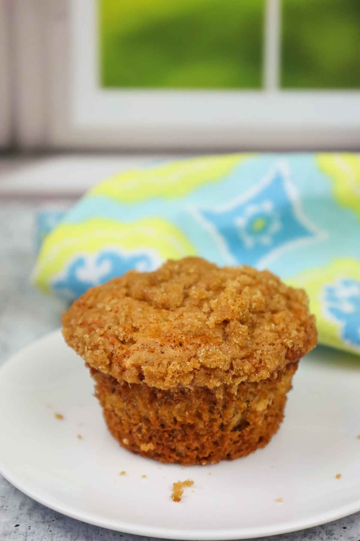 Banana Crumb muffin on a white plate.