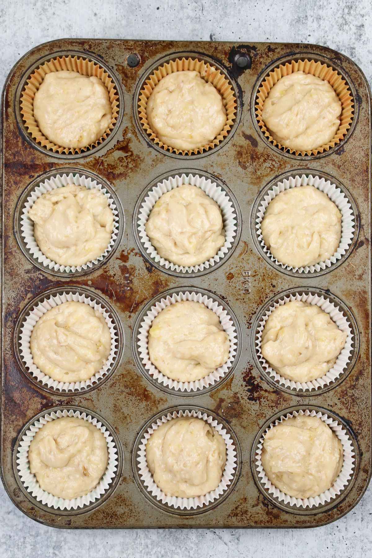 Banana crumb muffin batter in muffin pan.