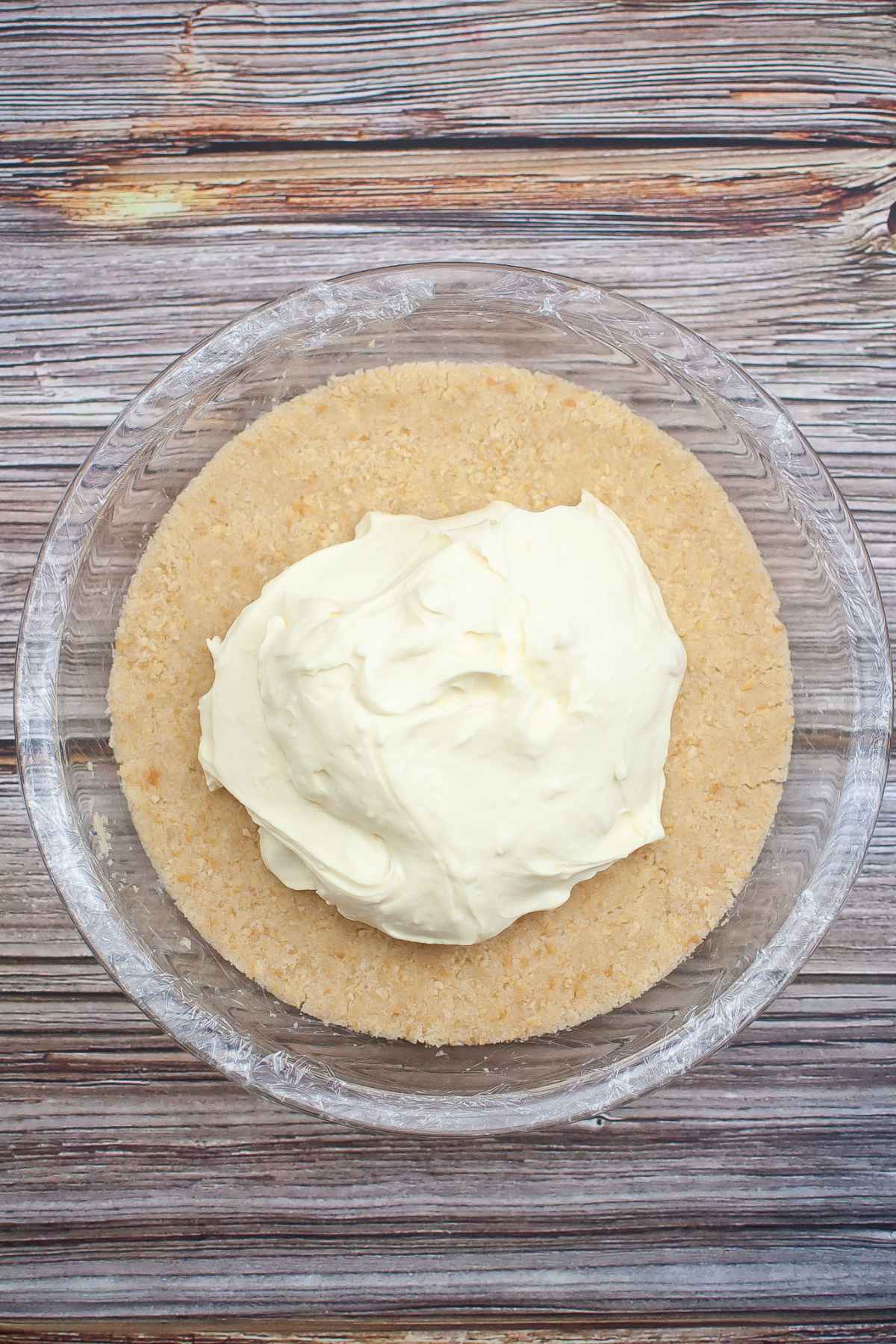 Cheesecake filling on top of cookie crust in a pie plate.