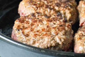 cooked beef patties in the skillet