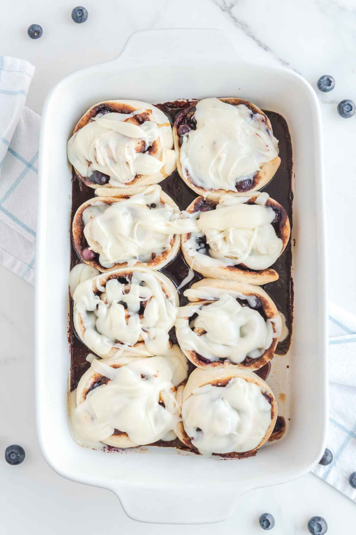 Overhead image of rolls with cream cheese icing.