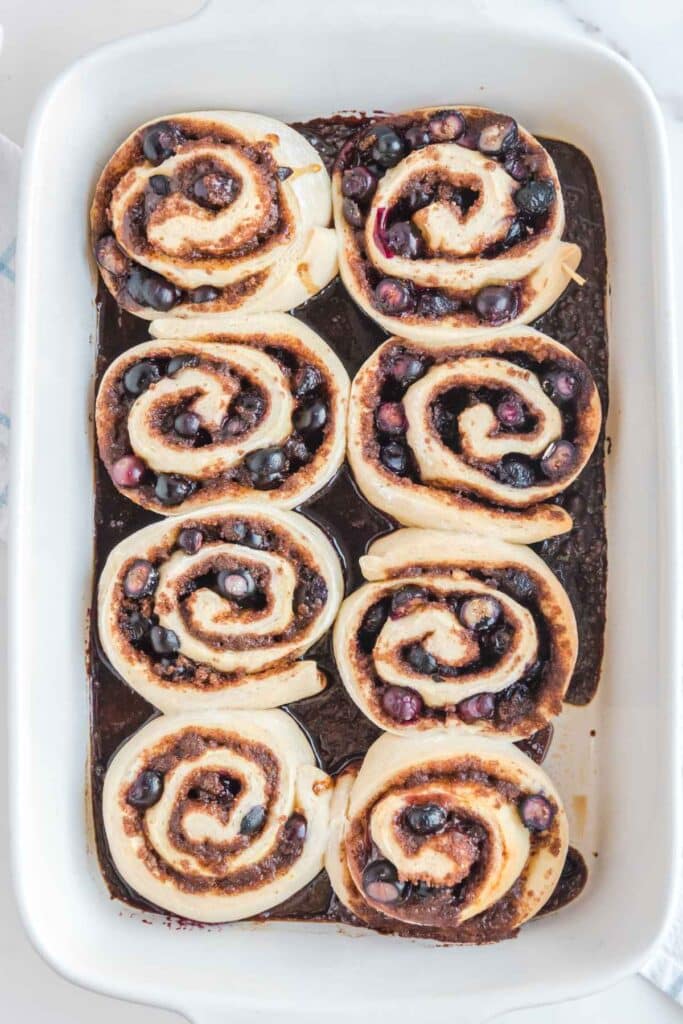 Overhead image of baked blueberry cinnamon rolls without icing.