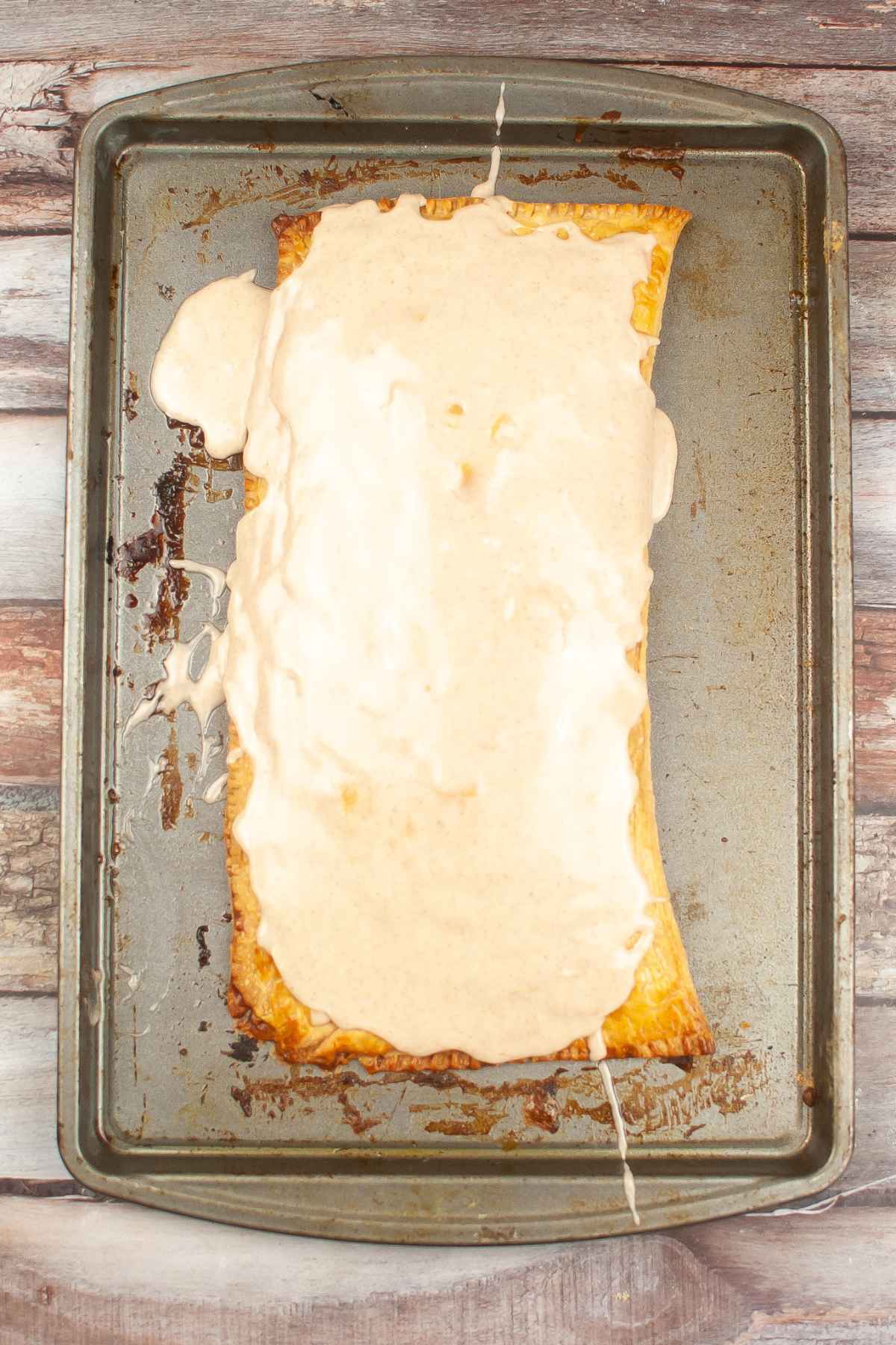 Fully glazed poptart on a baking sheet.