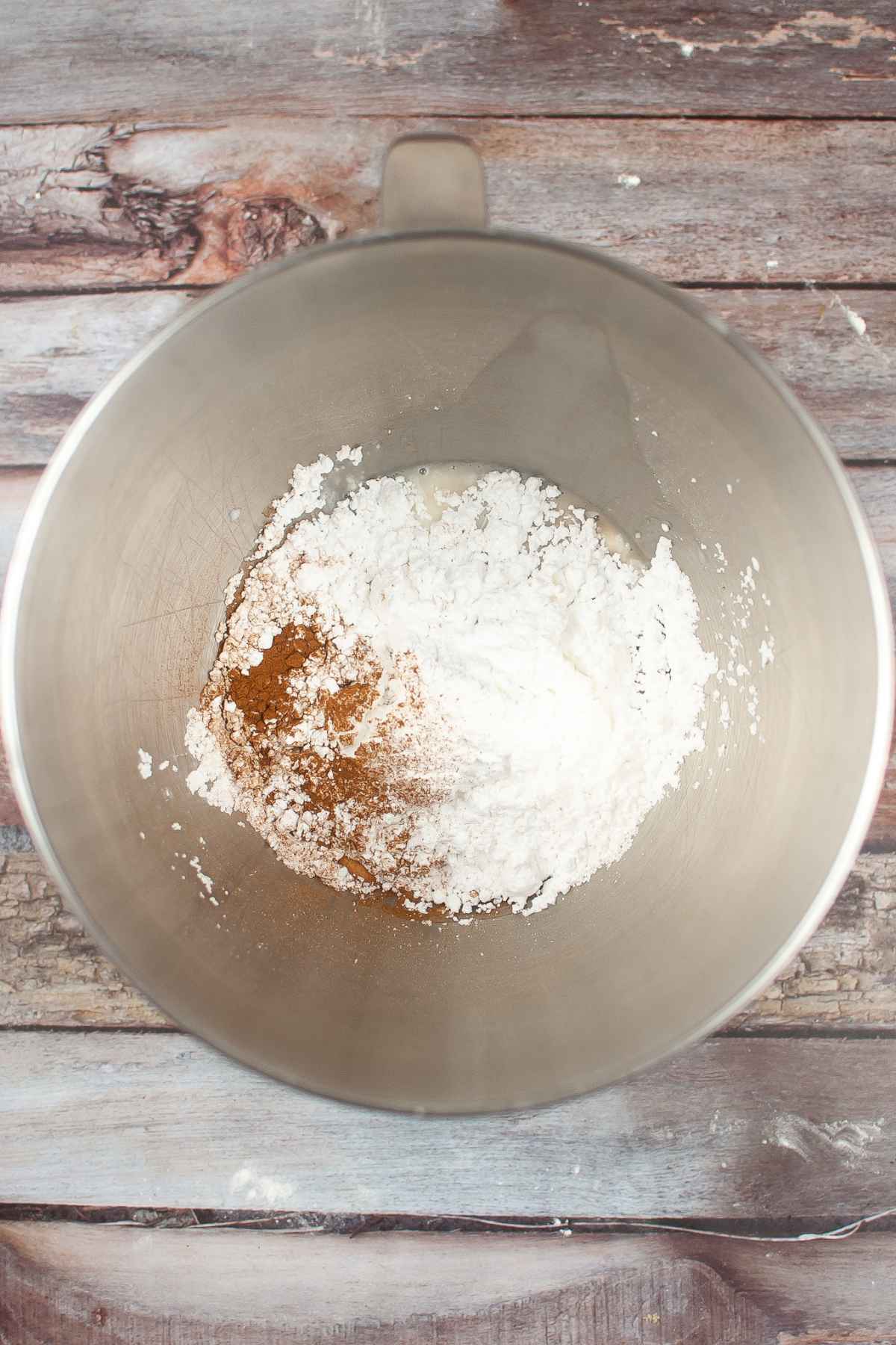 Powdered sugar, cinnamon, and milk in mixing bowl.