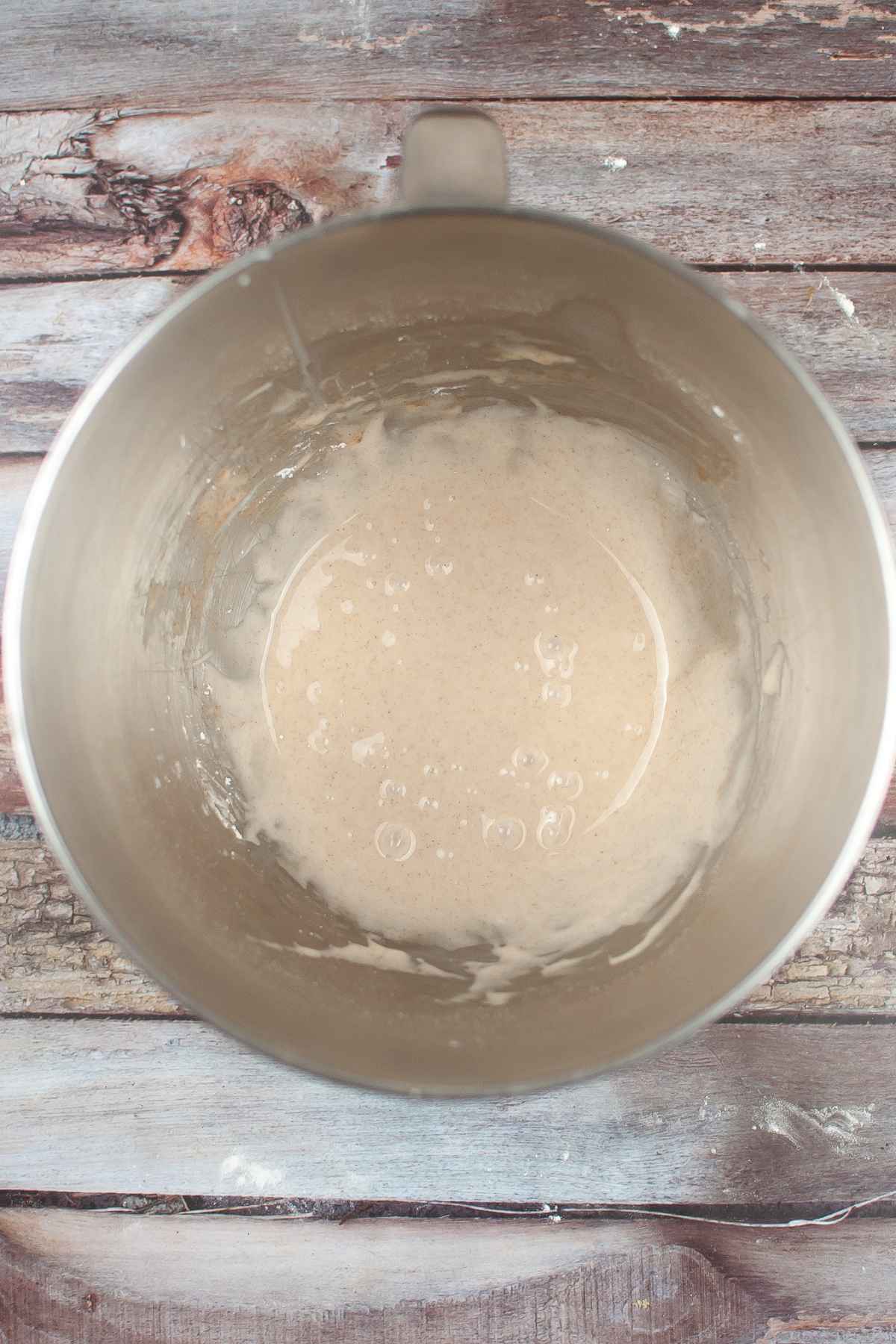 Cinnamon flavored icing in a mixing bowl.