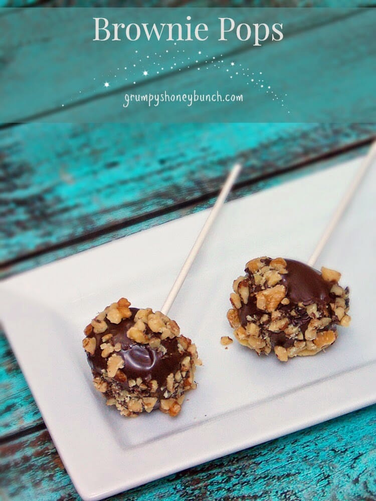 Brownie Pops with walnut coating on a white tray.