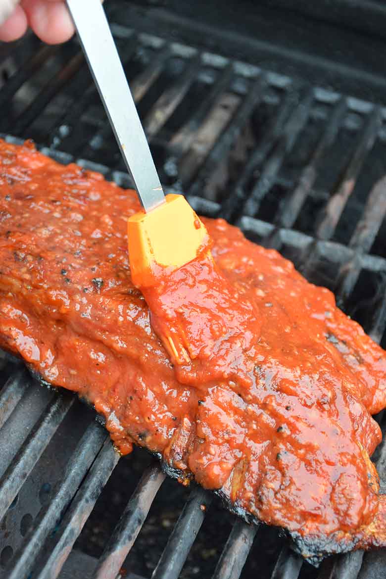 brushing the sugar-free barbecue sauce on the pork back ribs