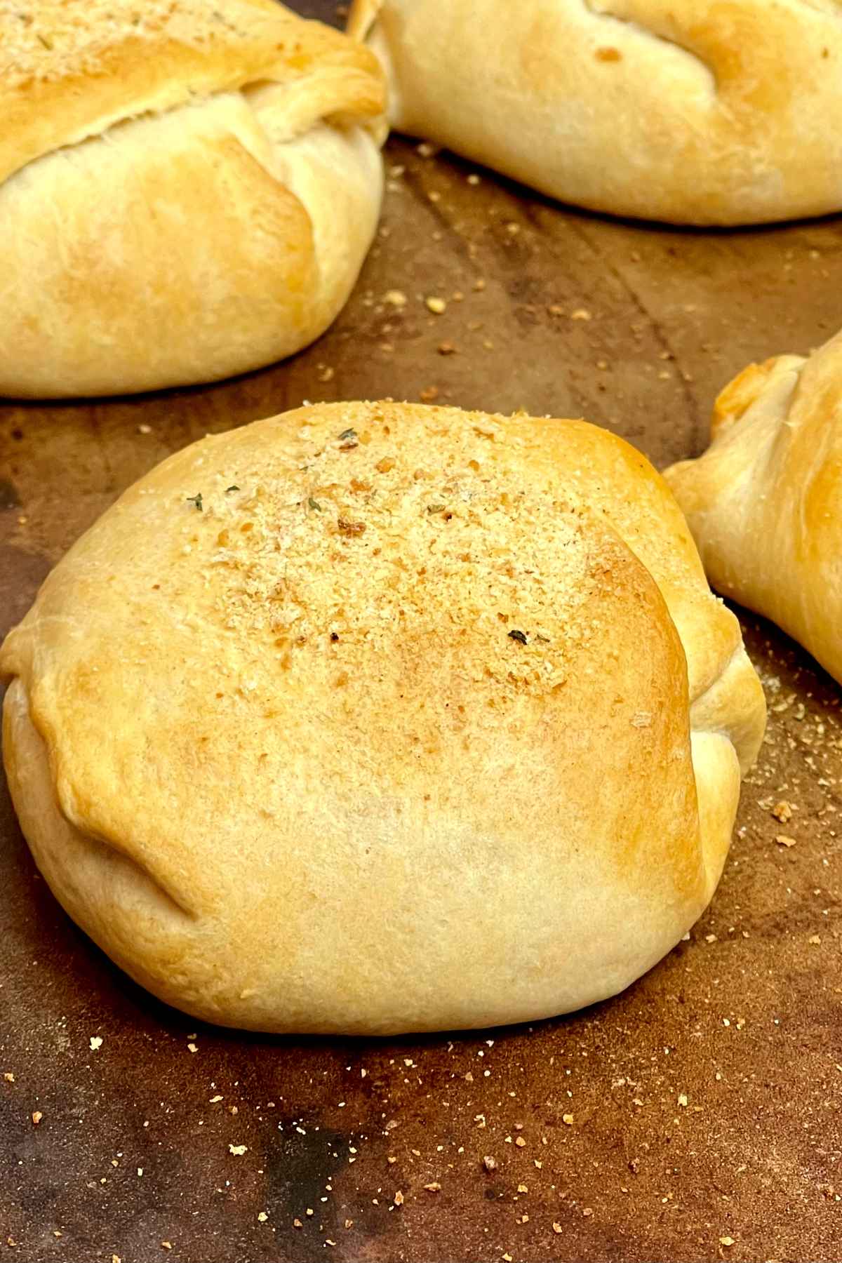 Baked buffalo chicken baseballs on a baking stone.