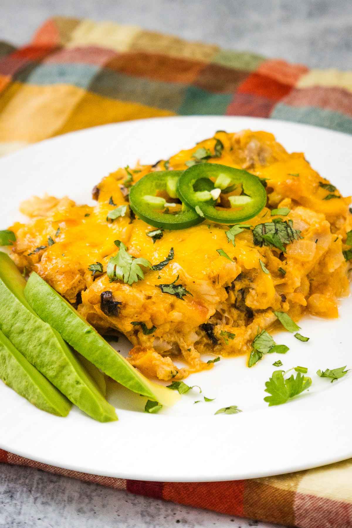 One serving of buffalo chicken casserole on a white plate.