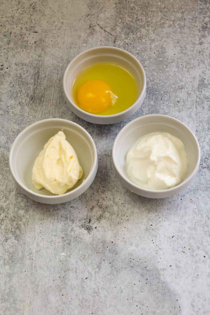 Egg, mayo, and sour cream in prep bowls.