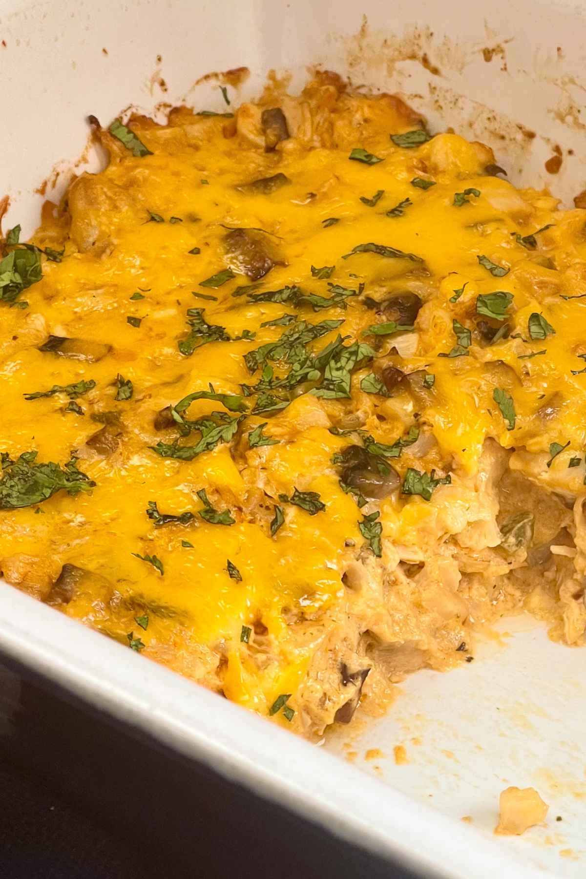 Baked keto buffalo chicken casserole with servings removed from the dish.