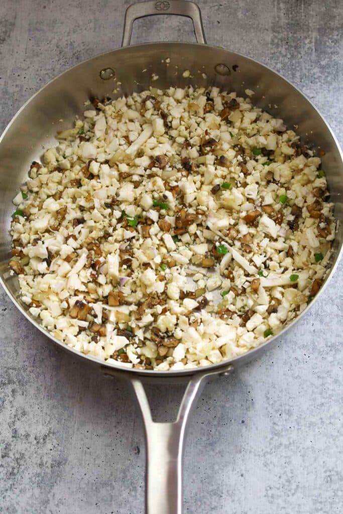 Cauliflower rice mixture in a skillet.