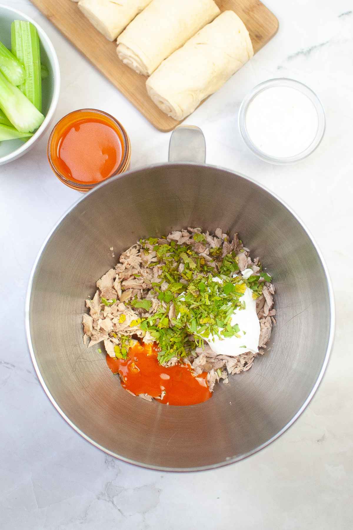 Chicken filling mixture in a mixing bowl.