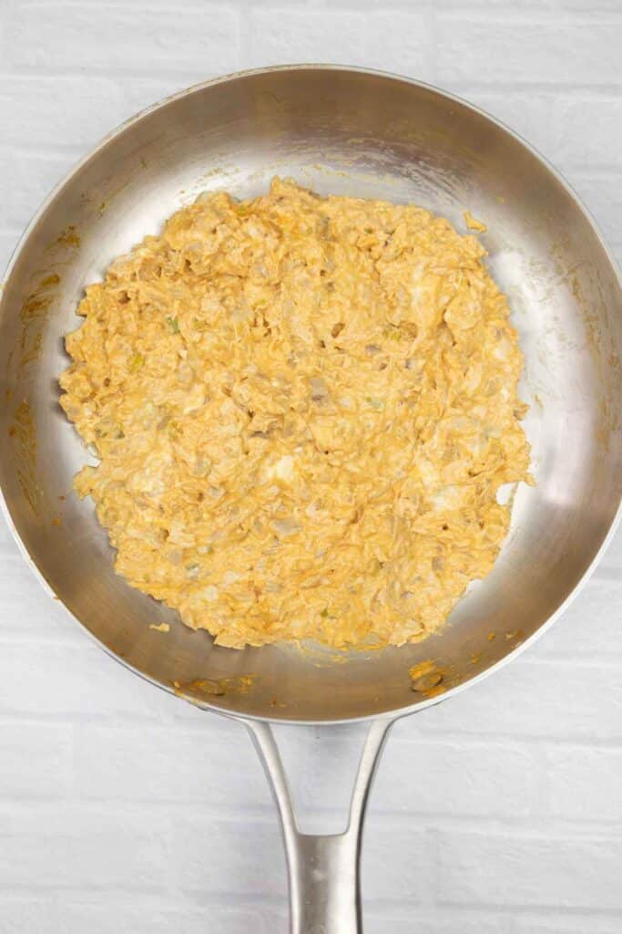 Buffalo chicken mixture in a large skillet.
