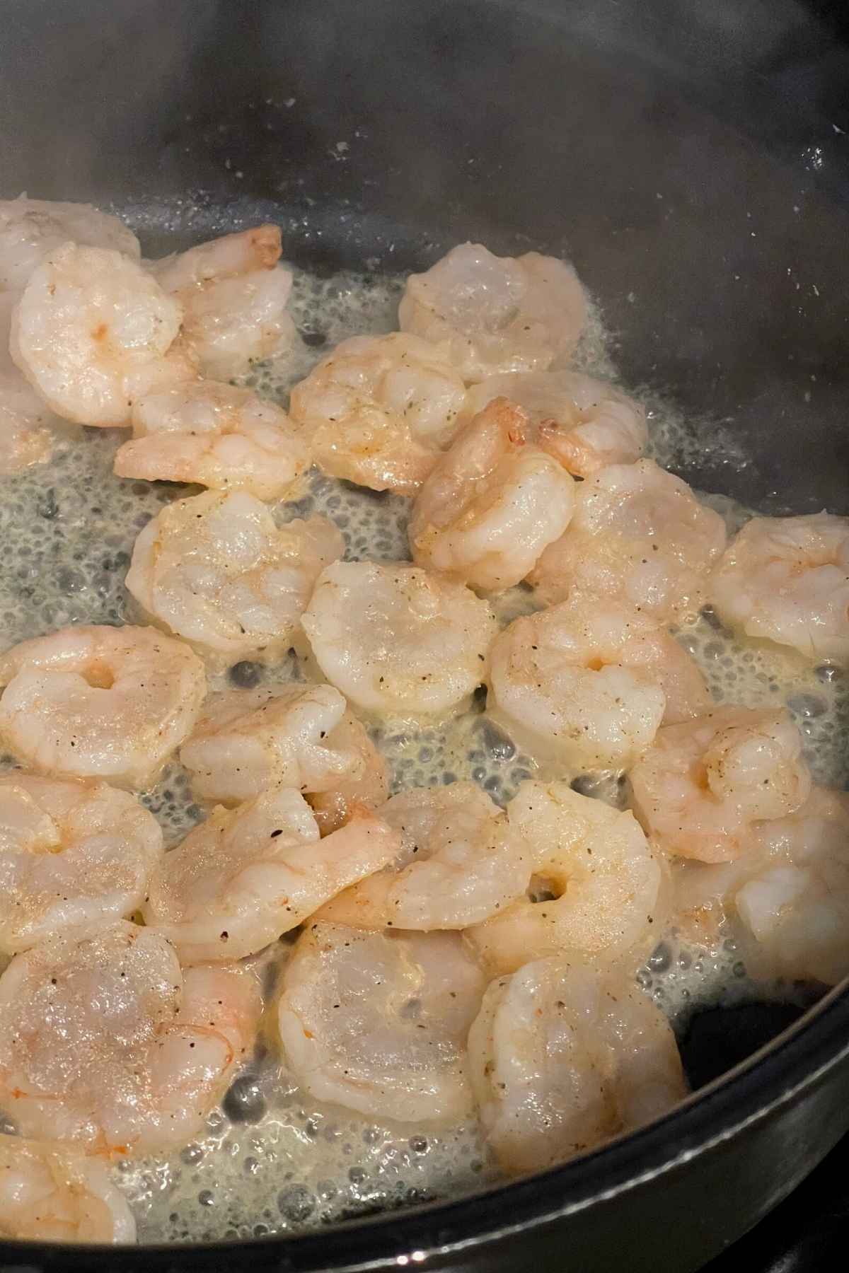 Shrimp cooking in a skillet.