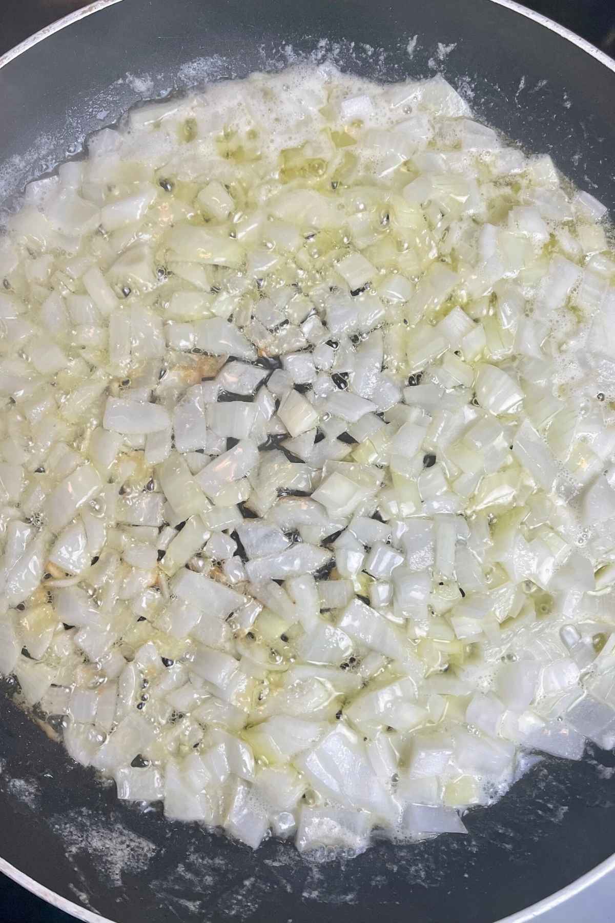 Sauteeing onions in butter in a skillet.