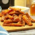 Featured image of an upclose view of air fryer carrot fries with crispy parmesan crust.