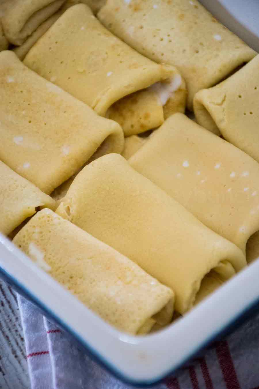 Cheese blintzes in a baking dish.