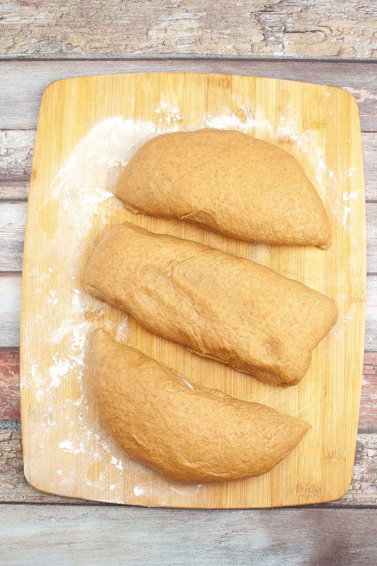 Bread dough divided into 3 equal portions.