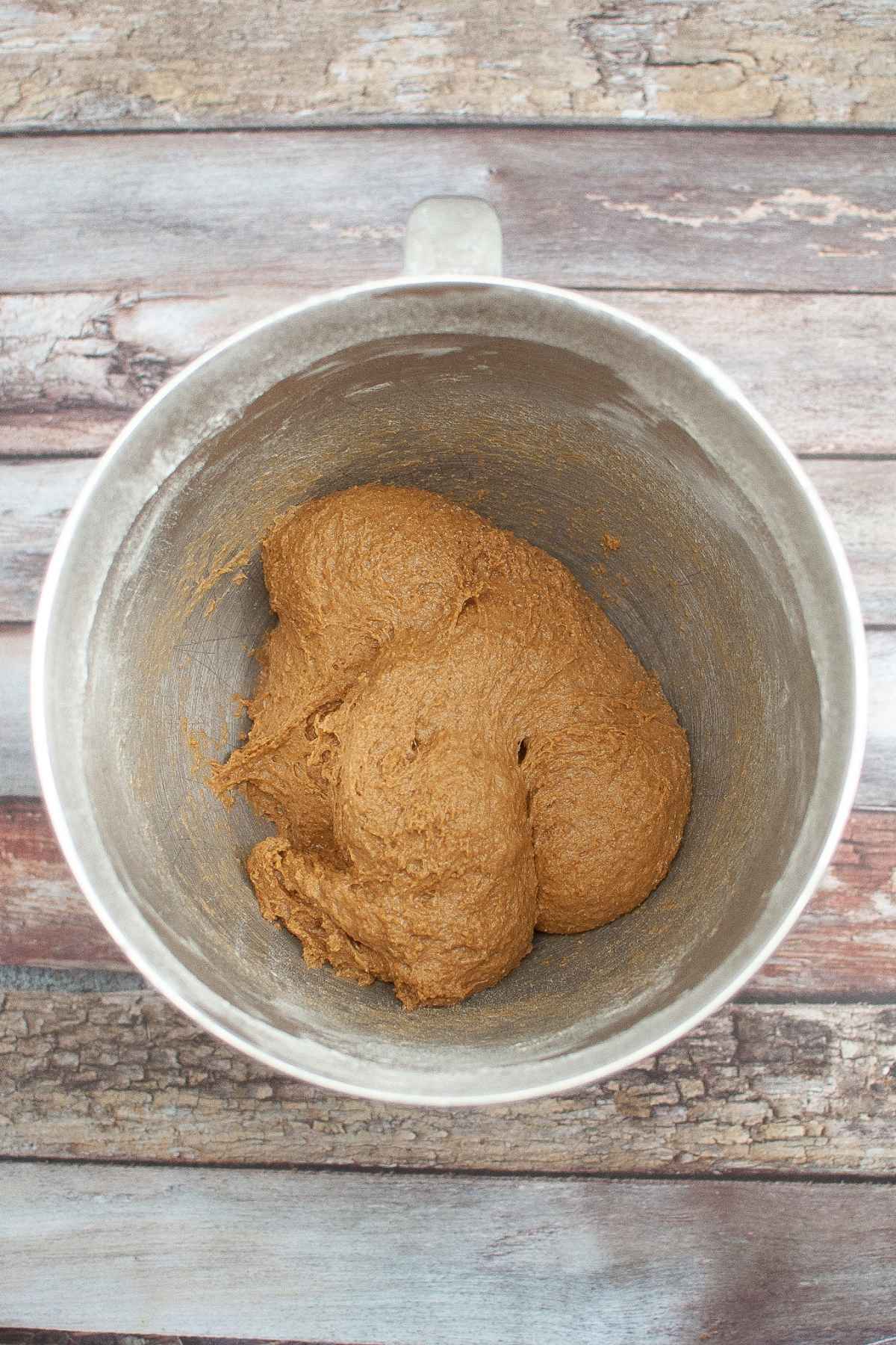 Brown bread dough in mixing bowl.