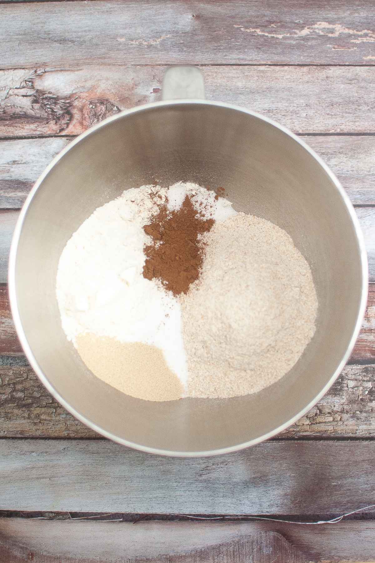 Dry ingredients for Cheesecake Factory Brown Bread in a stand mixer bowl.