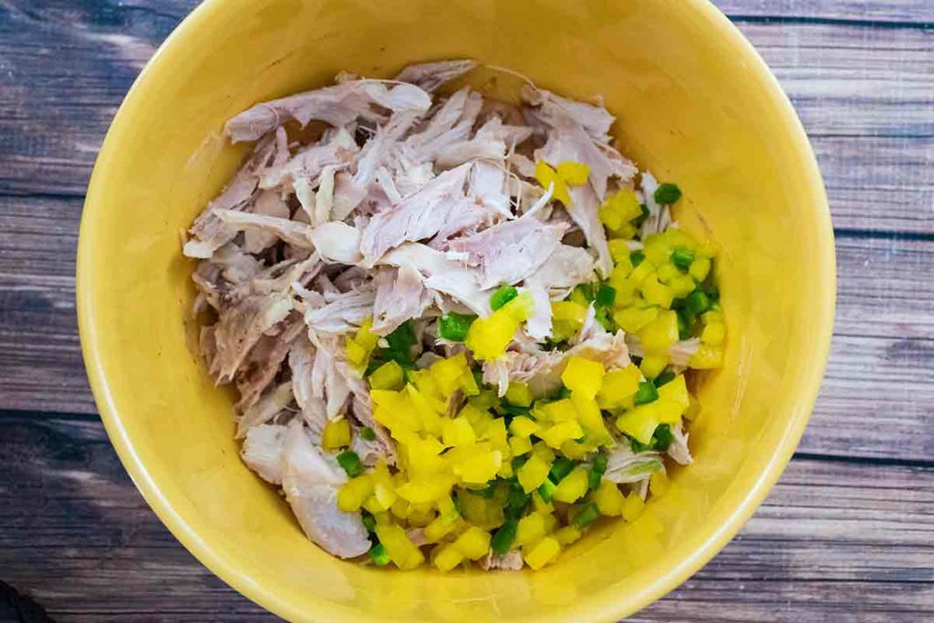 Chicken and peppers in mixing bowl