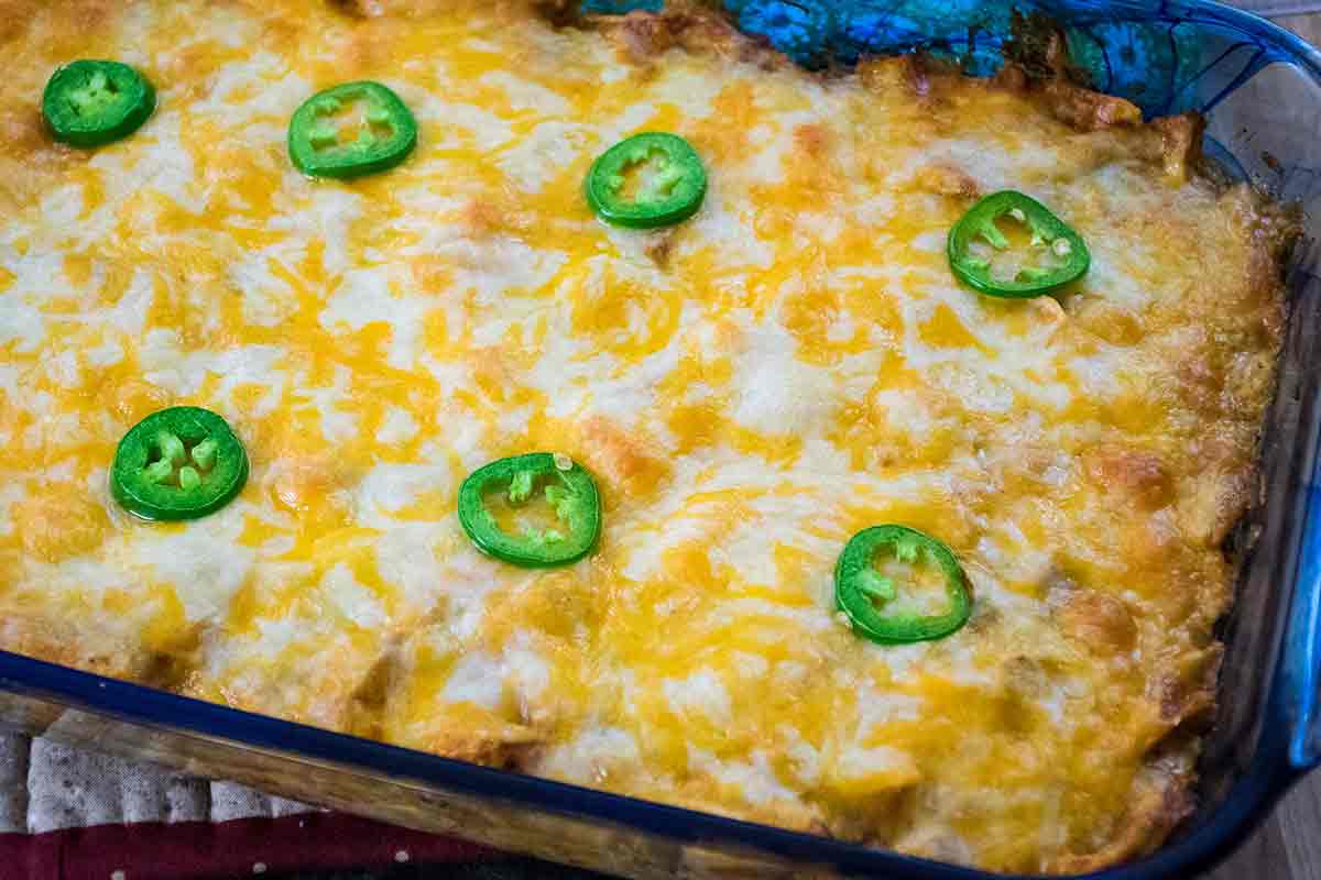 Baked Low Carb Chicken Enchilada Casserole topped with jalapeno slices.