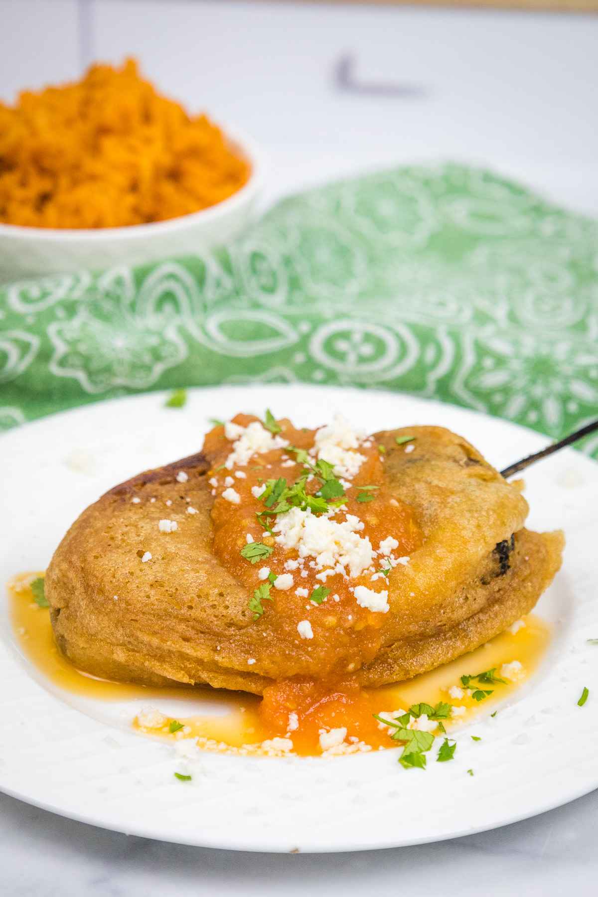 Hero shot of Chile Rellenos with Salsa Rojo.