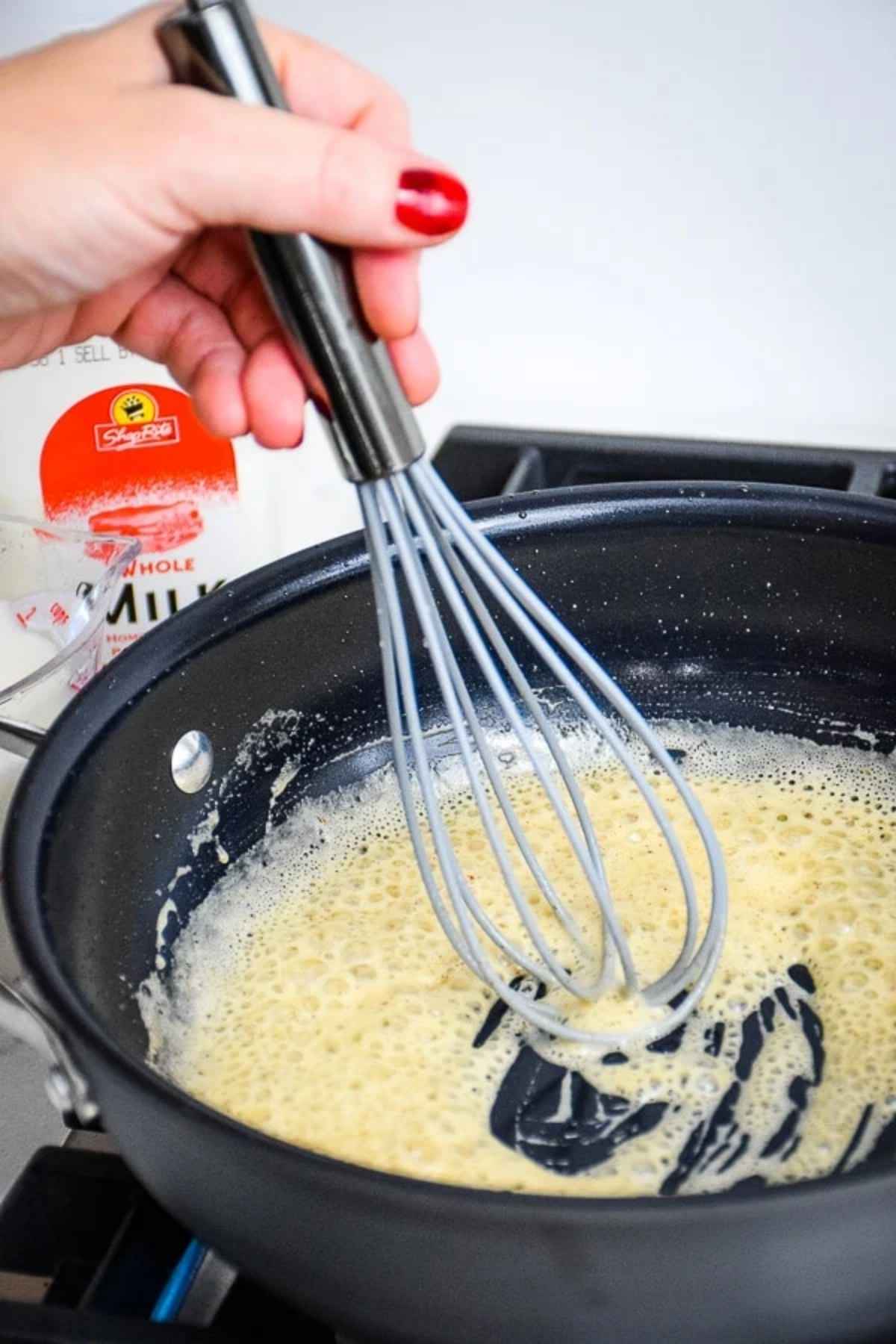Mixing the roux in the skillet.