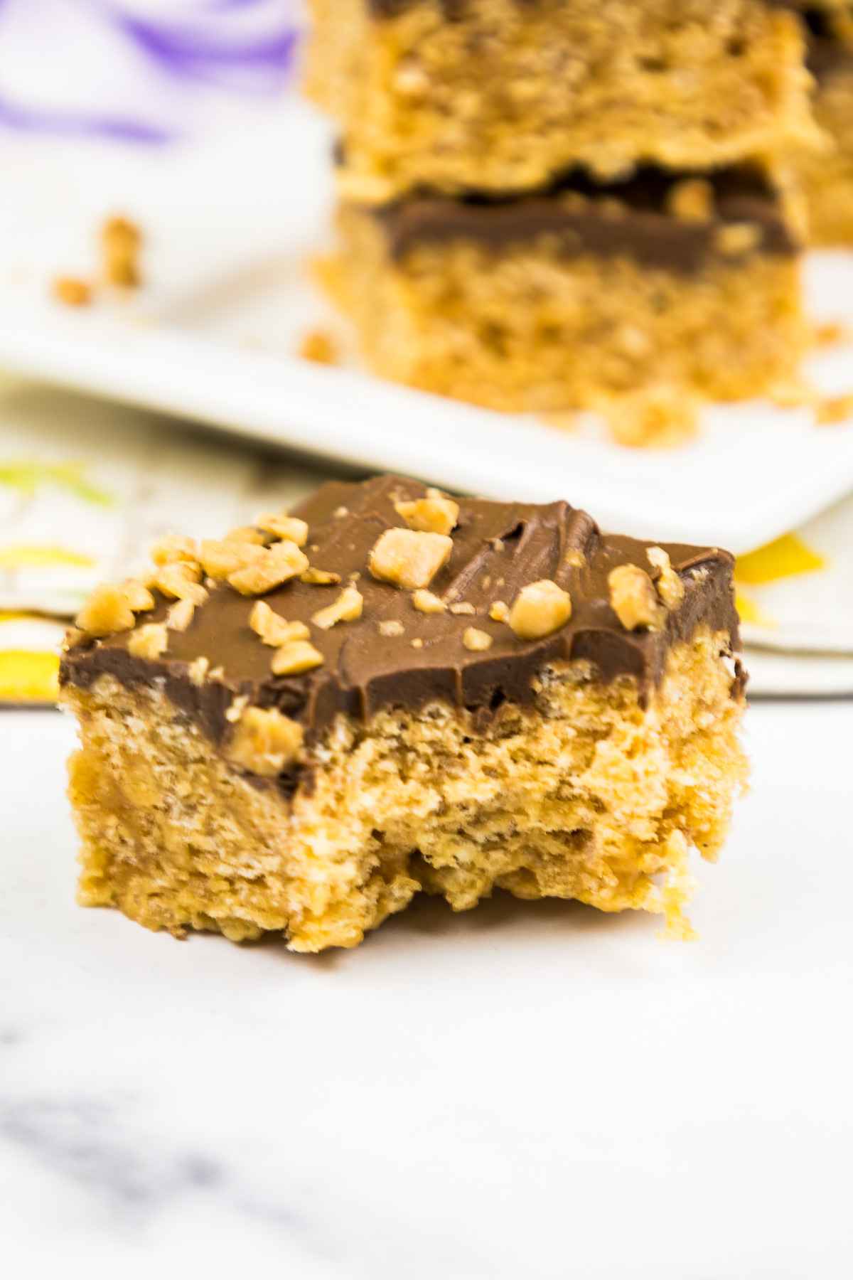 One no bake bar with a bite taken from with more bars in the background.