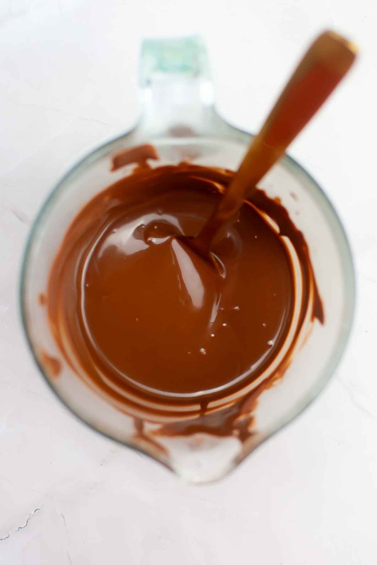 Melted chocolate wafers in a glass bowl.