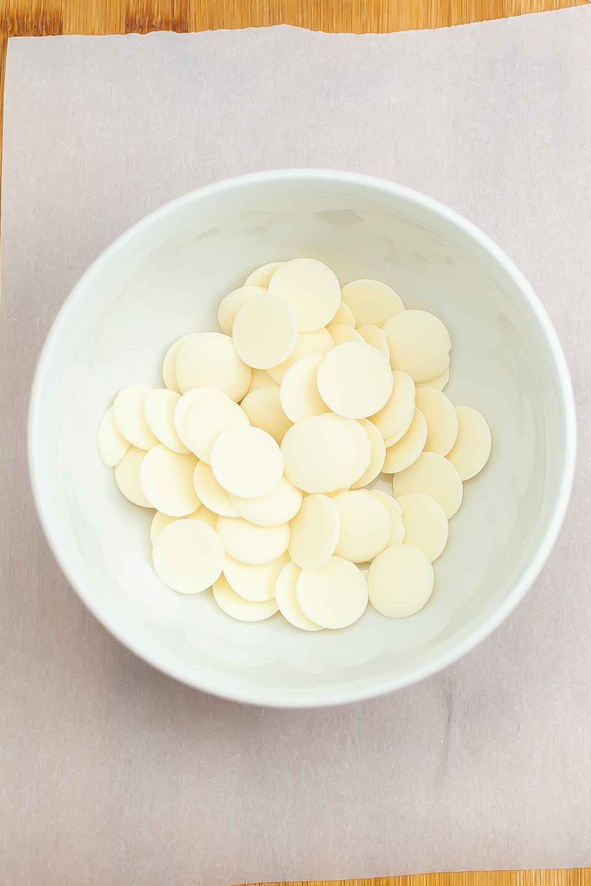 White chocolate candy melts in microwave-safe bowl.