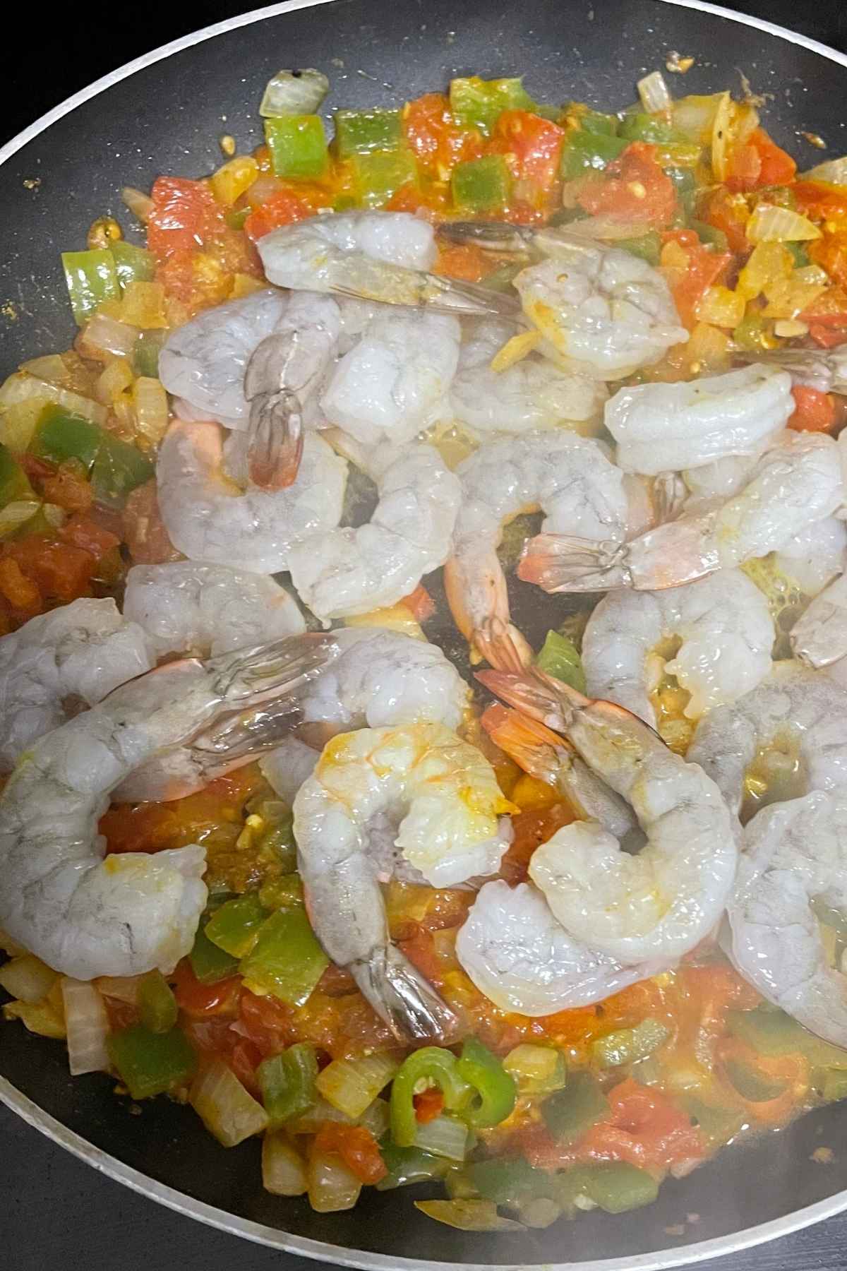 Shrimp cooking in the veggies with curry sauce.