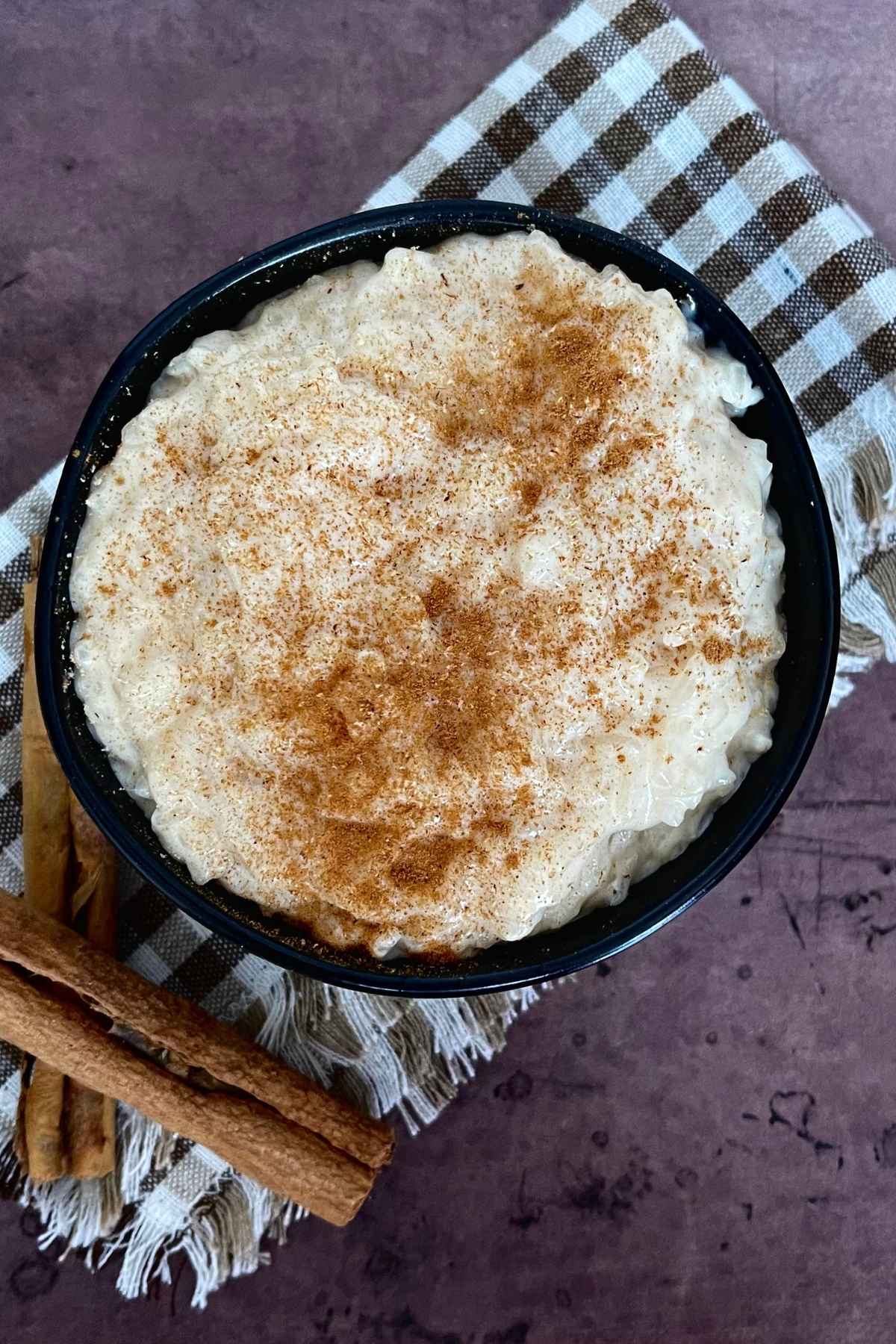 Overhead hero image of rice pudding with sweetened condensed milk.