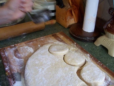Doughnut Dough that has been cut into circles with a biscuit cutter.