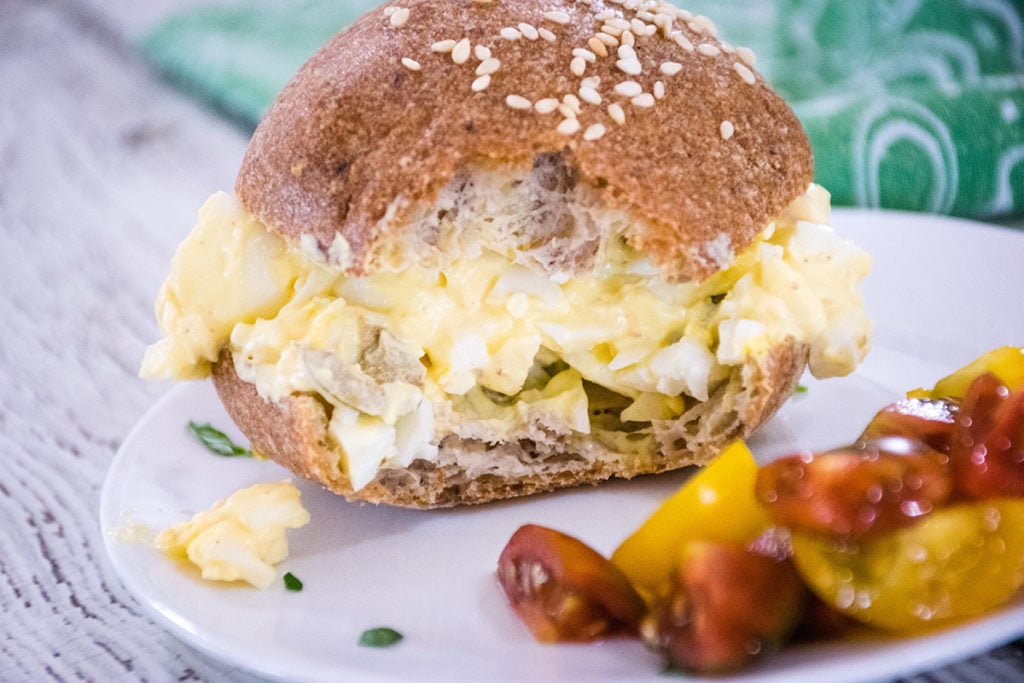 egg salad sandwich with a bite taken from it