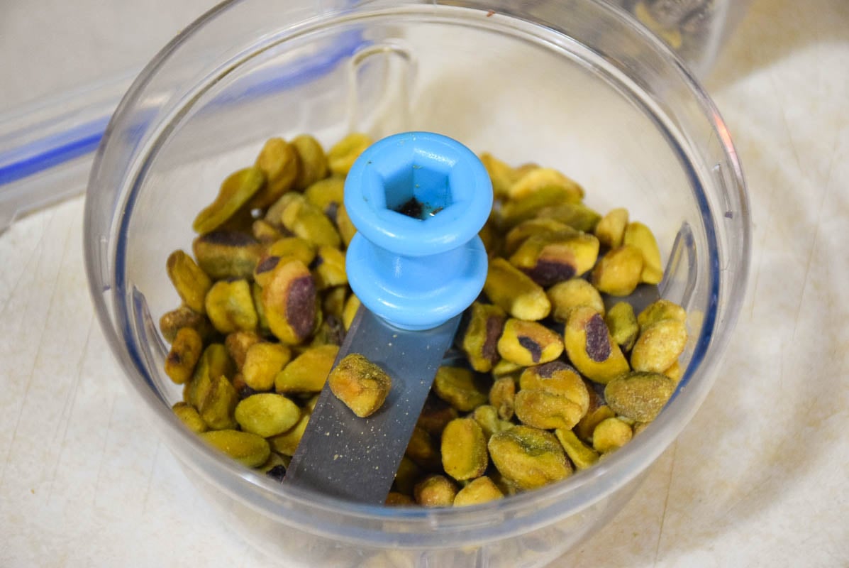 Pistachio nuts in a nut chopper.