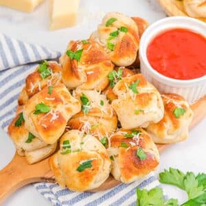 Featured image for Easy Air Fryer Garlic Knots with a side of marinara sauce.