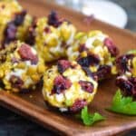 Up close image of goat cheese balls rolled in pistachio and cranberries.